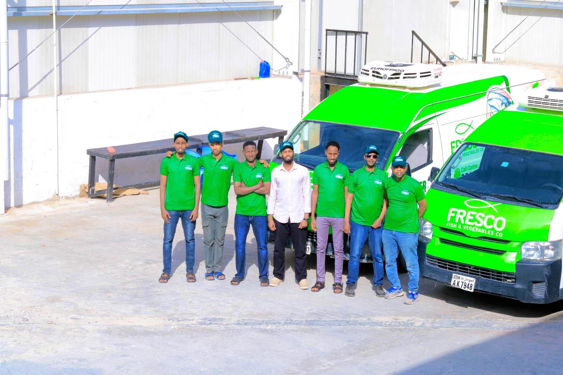 Fresco Fish & Vegetables branded delivery vans parked in the company yard